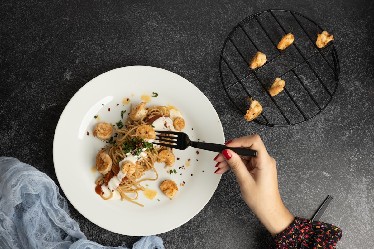 Fresh whole foods including vegetables, grains, and legumes arranged on a wooden table
